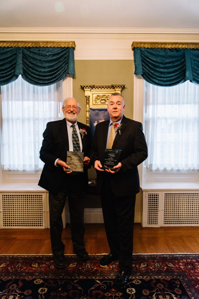 David Blocher, Volunteer, and Ken Albert, President and CEO, proudly display their Alliance awards.